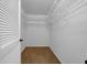 Spacious walk-in closet featuring white wire shelving and neutral carpet at 1969 Wolf Laurel Dr, Sun City Center, FL 33573