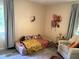 Cozy bedroom with wood floors, comfortable seating, and natural light from the window at 205 Park Ridge Ave, Temple Terrace, FL 33617