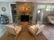 Charming stone fireplace with a wooden mantle, surrounded by comfortable seating, creating a cozy focal point at 205 Park Ridge Ave, Temple Terrace, FL 33617