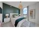 Cozy bedroom with a green accent wall, chandelier, and view of the water at 2103 Bayshore Blvd # 1701, Tampa, FL 33606