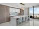 Modern kitchen with sleek cabinets, quartz island, and floor-to-ceiling windows with a water view at 2103 Bayshore Blvd # 1701, Tampa, FL 33606