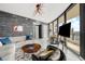 Stylish living room with modern furniture, a textured accent wall, and expansive views at 2103 Bayshore Blvd # 1701, Tampa, FL 33606