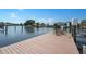 A wooden dock with chairs awaits on the waterfront, offering stunning views and relaxation at 221 Tallahassee Ne Dr, St Petersburg, FL 33702