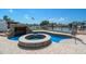 Beautiful pool area features custom stone waterfall and connected spa, perfect for entertaining at 221 Tallahassee Ne Dr, St Petersburg, FL 33702