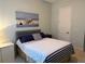Bedroom featuring light-green walls, striped bedding, a nautical-themed picture, and a white door at 2217 5Th E St, Palmetto, FL 34221