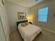 A small bedroom with neutral decor and a double bed at 2217 5Th E St, Palmetto, FL 34221