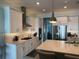 Contemporary kitchen featuring white cabinets, stainless steel appliances, and a spacious island with a sink at 2217 5Th E St, Palmetto, FL 34221