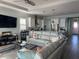 Bright and airy living room flowing into a modern kitchen with white cabinets and stainless steel appliances at 2217 5Th E St, Palmetto, FL 34221