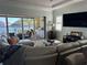 Cozy living area with view of a lake, sliding glass doors, grill, comfortable seating, and a large TV at 2217 5Th E St, Palmetto, FL 34221
