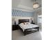 Serene main bedroom featuring elegant lighting, stylish decor, and comfortable furnishings for a relaxing retreat at 2217 5Th E St, Palmetto, FL 34221