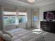 Bright primary bedroom features a view of the water, a flatscreen TV, and multiple windows for natural light at 2217 5Th E St, Palmetto, FL 34221