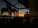 The covered patio is perfect for evening relaxation with sunset views, a hot tub, and an outdoor kitchen at 2217 5Th E St, Palmetto, FL 34221