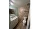 Bathroom features a vanity with sink, toilet, mirror, and tiled walls at 2971 Estancia Blvd # 225, Clearwater, FL 33761