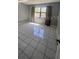 Bedroom with tile floor, gray walls, a large window and neutral curtains at 2971 Estancia Blvd # 225, Clearwater, FL 33761