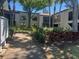 Exterior view of a condo building with manicured landscaping and a walkway leading to the entrance at 2971 Estancia Blvd # 225, Clearwater, FL 33761