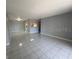 Open living room with sleek tile flooring and a pass-through to the kitchen providing seamless flow at 2971 Estancia Blvd # 225, Clearwater, FL 33761