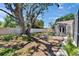 Expansive backyard featuring a screened lanai and mature tree, perfect for outdoor entertaining at 3004 Rolling Acres Pl, Valrico, FL 33596