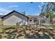 Backyard view featuring a screened-in patio, freshly landscaped yard, and privacy at 3004 Rolling Acres Pl, Valrico, FL 33596