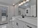 Updated bathroom features a large mirror, quartz counters, and stylish black fixtures at 3004 Rolling Acres Pl, Valrico, FL 33596
