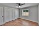 Inviting bedroom features a ceiling fan, hardwood floors, and spacious closets at 3004 Rolling Acres Pl, Valrico, FL 33596