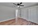 Inviting bedroom features a ceiling fan, hardwood floors, and spacious closets at 3004 Rolling Acres Pl, Valrico, FL 33596
