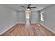 Bright bedroom featuring hardwood floors, recessed lights, ceiling fan, and walk-in closet at 3004 Rolling Acres Pl, Valrico, FL 33596
