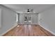 Well lit open bedroom with hardwood floors, recessed lights, ceiling fan, and access to patio at 3004 Rolling Acres Pl, Valrico, FL 33596