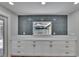 Stylish serving area with sleek white cabinets, stone countertop, and modern backsplash with pool view at 3004 Rolling Acres Pl, Valrico, FL 33596