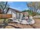 Charming single-story home with a white brick exterior, brown trim, landscaped yard, and mature trees at 3004 Rolling Acres Pl, Valrico, FL 33596
