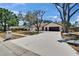 Charming single-story home with a long driveway and mature trees in a well-manicured front yard at 3004 Rolling Acres Pl, Valrico, FL 33596
