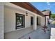 Exterior view of the home's covered walkway with accent lighting, white columns and decorative stones at 3004 Rolling Acres Pl, Valrico, FL 33596