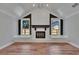 Living room featuring a vaulted ceiling and fireplace with black mantle and hearth at 3004 Rolling Acres Pl, Valrico, FL 33596