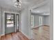 Freshly painted foyer with hardwood floors and a modern light fixture welcomes you into this charming home at 3004 Rolling Acres Pl, Valrico, FL 33596