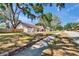 Charming home exterior with a landscaped front yard and inviting walkway at 3004 Rolling Acres Pl, Valrico, FL 33596
