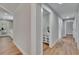 Long hallway offers modern floors, neutral walls, and a clear view of the home's bright interior at 3004 Rolling Acres Pl, Valrico, FL 33596