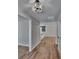 Inviting hallway with new flooring, fresh paint, and views of the kitchen and living spaces at 3004 Rolling Acres Pl, Valrico, FL 33596