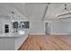 Open-concept kitchen and living area with vaulted ceilings at 3004 Rolling Acres Pl, Valrico, FL 33596