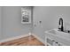 Bright laundry room with modern fixtures including a sink and a window at 3004 Rolling Acres Pl, Valrico, FL 33596