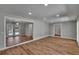 Open-concept living room featuring neutral gray walls and stylish plank flooring at 3004 Rolling Acres Pl, Valrico, FL 33596