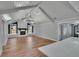 Bright living room with vaulted ceiling, exposed beams, modern lighting, and cozy fireplace at 3004 Rolling Acres Pl, Valrico, FL 33596