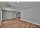 Spacious living room boasts hardwood floors and recessed lighting at 3004 Rolling Acres Pl, Valrico, FL 33596