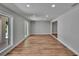 Spacious and bright living room featuring luxury vinyl flooring and neutral paint colors at 3004 Rolling Acres Pl, Valrico, FL 33596