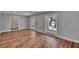 Bright living room featuring luxury vinyl flooring and multiple windows allowing natural light at 3004 Rolling Acres Pl, Valrico, FL 33596
