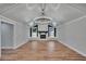 Bright living room with vaulted ceiling, exposed beams, modern lighting, and cozy fireplace at 3004 Rolling Acres Pl, Valrico, FL 33596