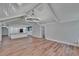 Open-concept living room featuring vaulted ceiling, modern chandelier, and view to kitchen area at 3004 Rolling Acres Pl, Valrico, FL 33596