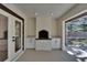 Outdoor patio features a brick fireplace, white cabinets, and screened enclosure at 3004 Rolling Acres Pl, Valrico, FL 33596