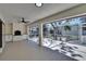 Outdoor patio with a fireplace, screened enclosure, and tile flooring at 3004 Rolling Acres Pl, Valrico, FL 33596