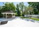 Backyard featuring a gazebo, pool, and mature trees at 3302 W Caracas St, Tampa, FL 33614
