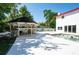 Backyard oasis with a gazebo, pool, and white fencing at 3302 W Caracas St, Tampa, FL 33614