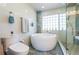 Stylish bathroom with a round soaking tub, glass shower, and modern fixtures at 3302 W Caracas St, Tampa, FL 33614